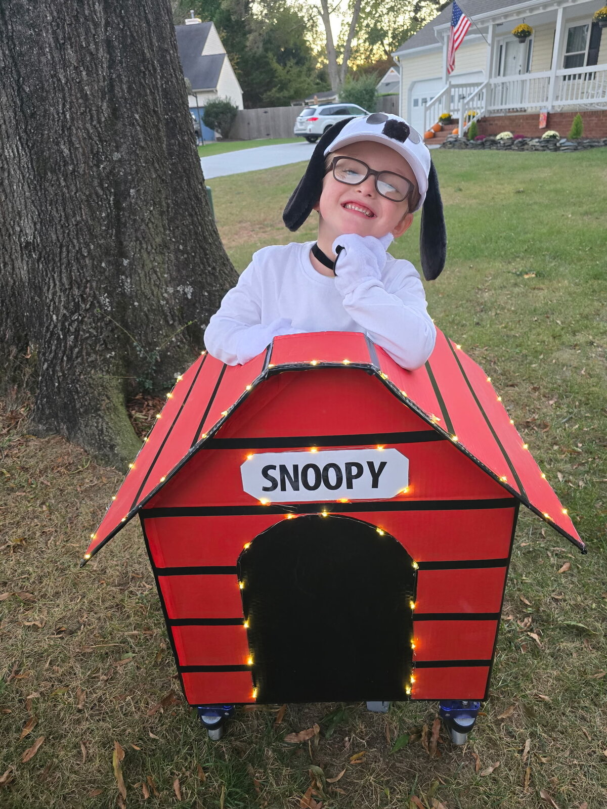 Child in a Snoopy costume on wheels