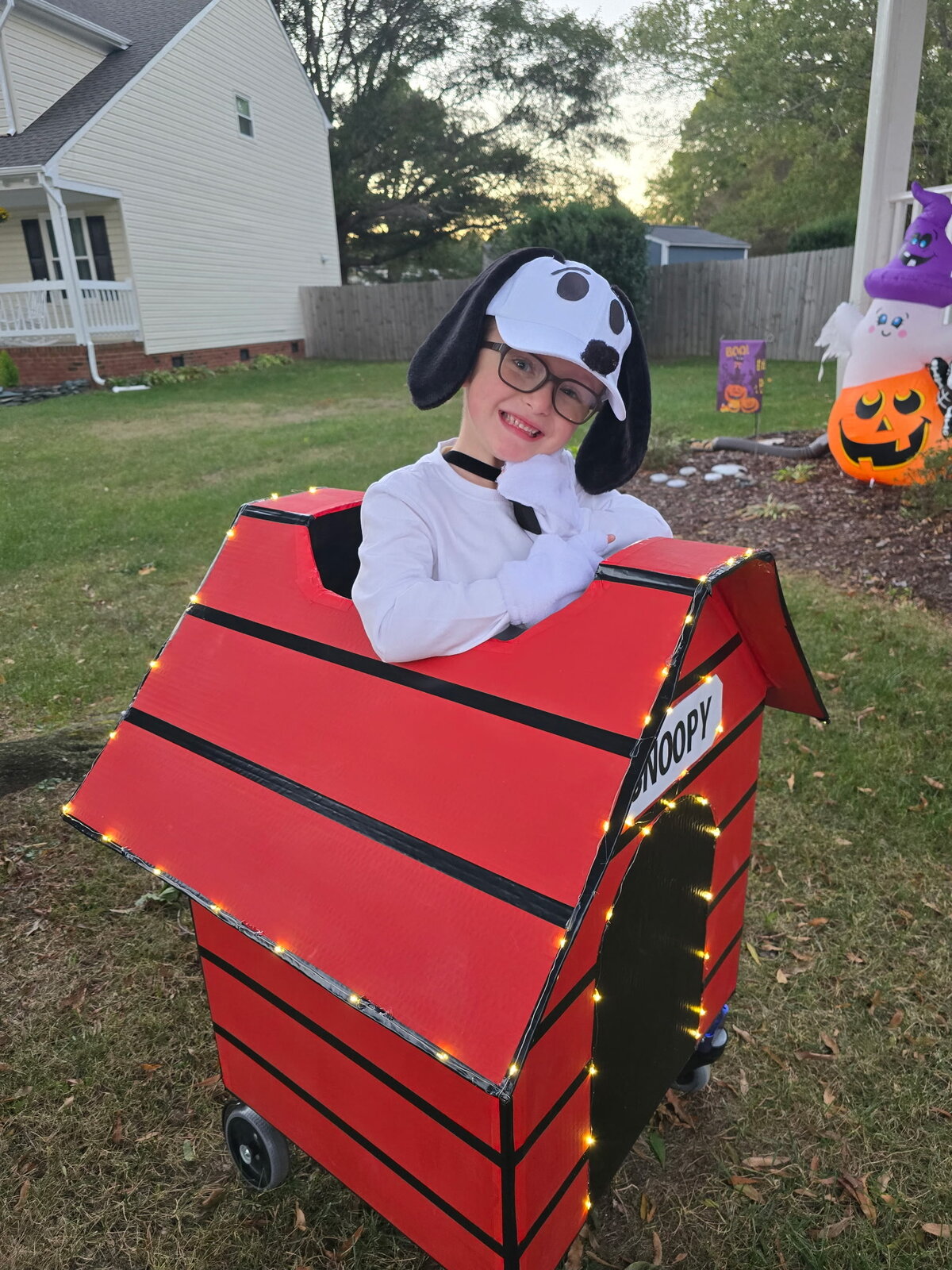 Child in a Snoopy costume on wheels