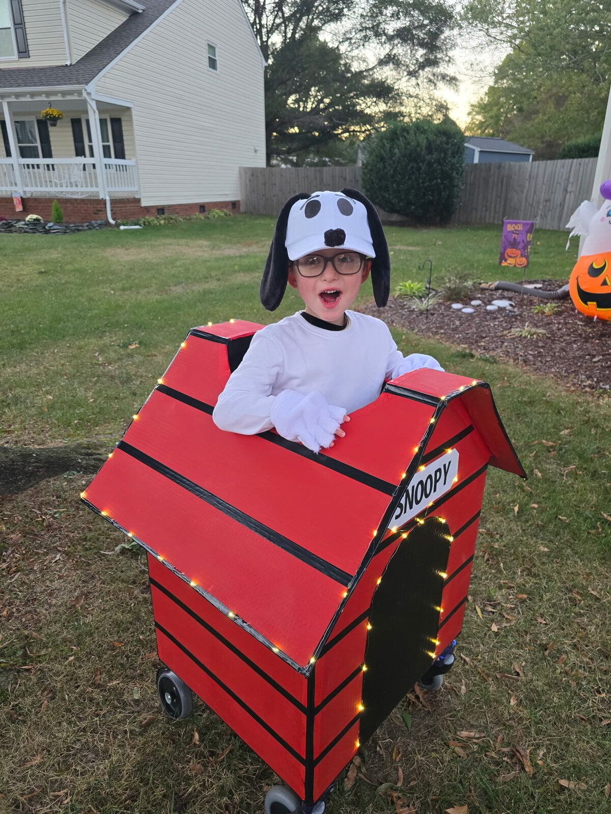 Child in a Snoopy costume on wheels