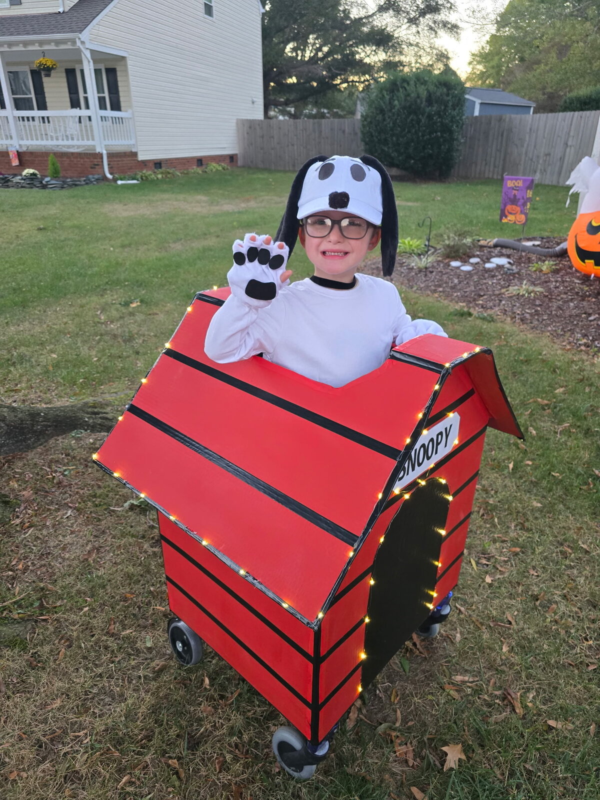 Child in a Snoopy costume on wheels