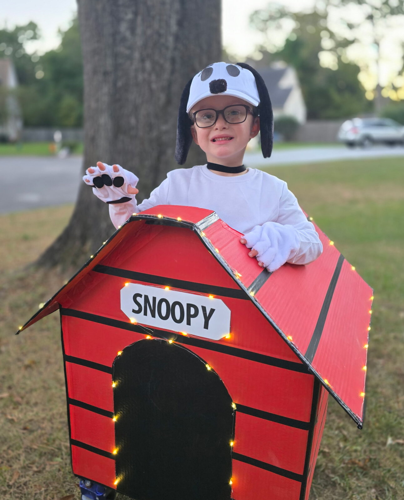 Child in a Snoopy costume on wheels
