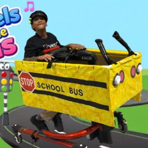 Child in a Wheels on the Bus costume on wheels