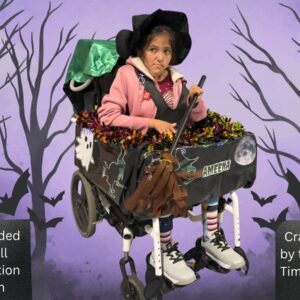 Child in a Witch costume on wheels