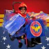 Child in a Wonder Woman costume on wheels