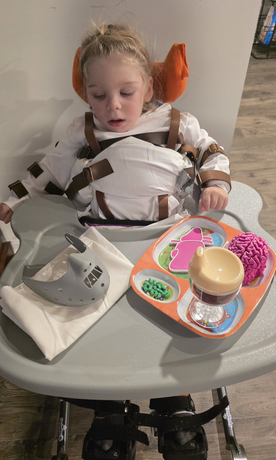 Child in a Hannibal Lecter costume on wheels