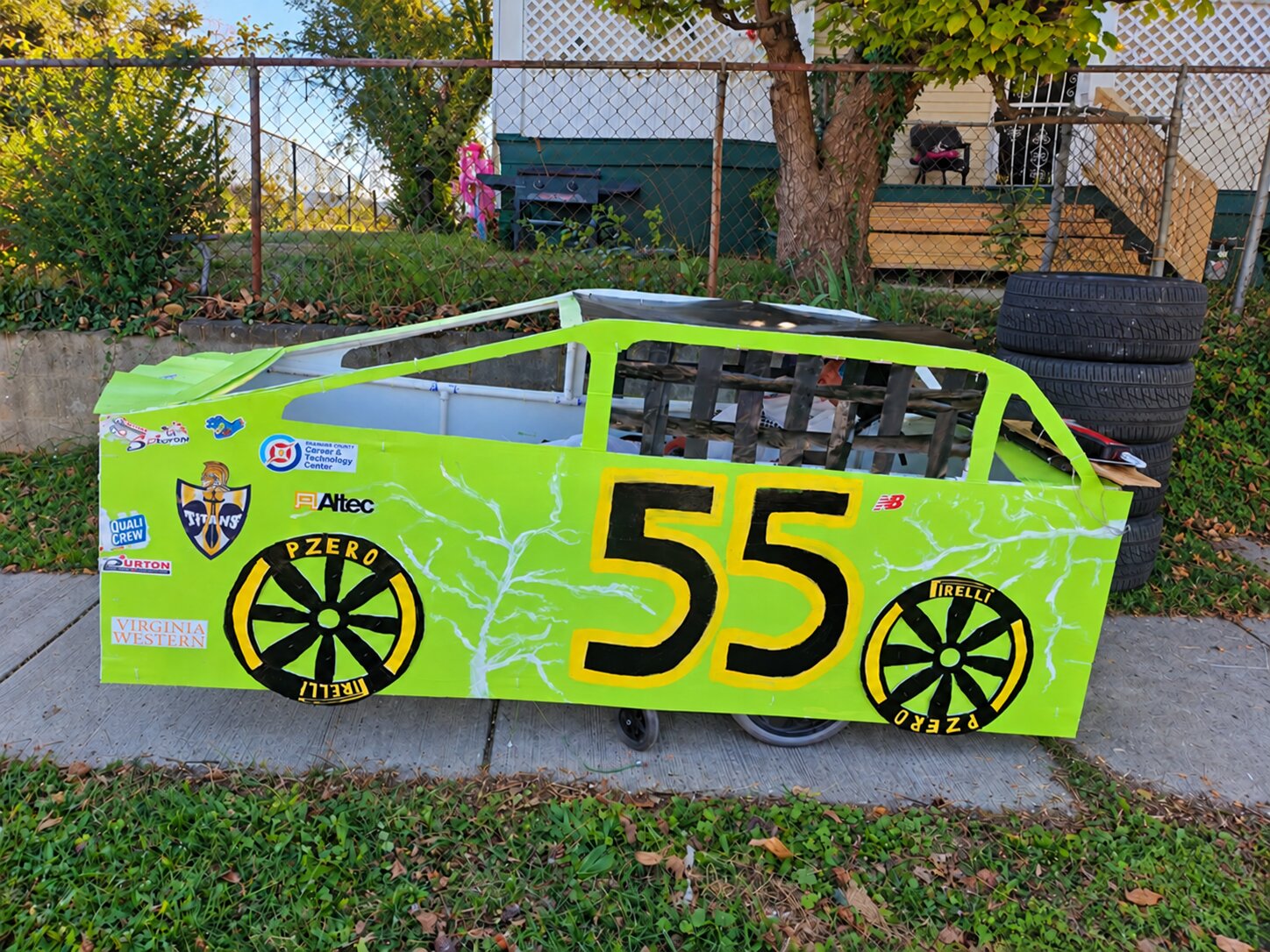 Child in a Number 55 costume on wheels