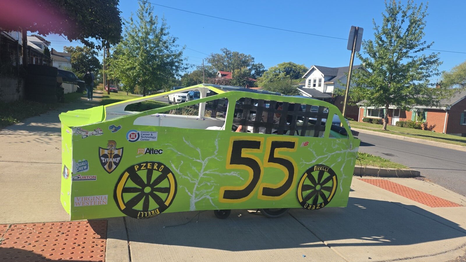 Child in a Number 55 costume on wheels