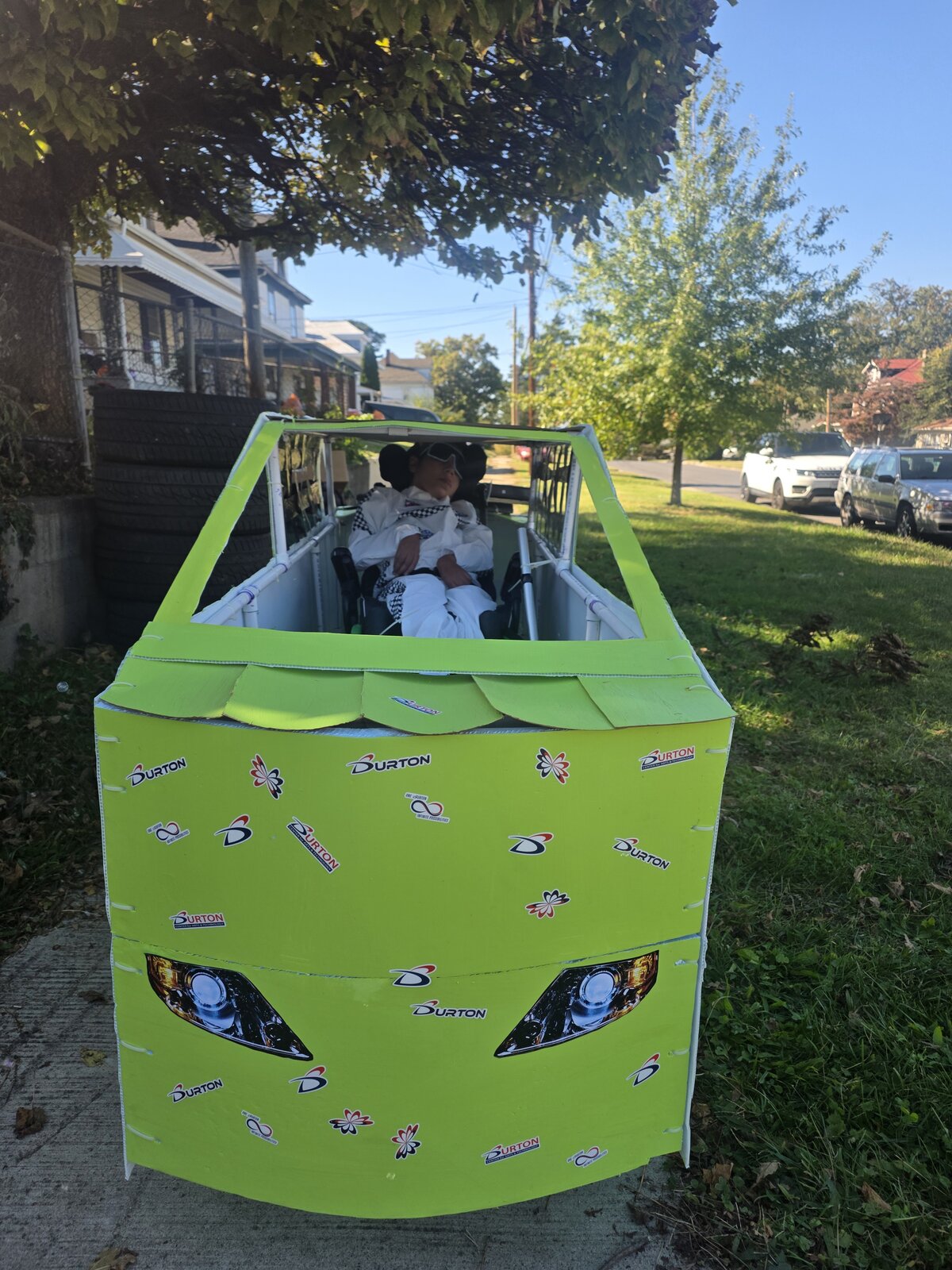 Child in a Number 55 costume on wheels