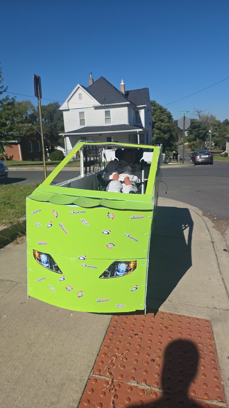 Child in a Number 55 costume on wheels