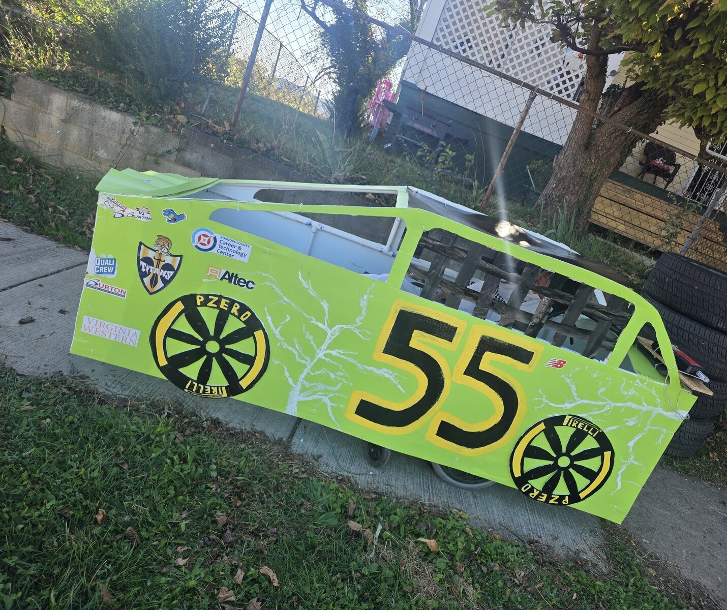Child in a Number 55 costume on wheels