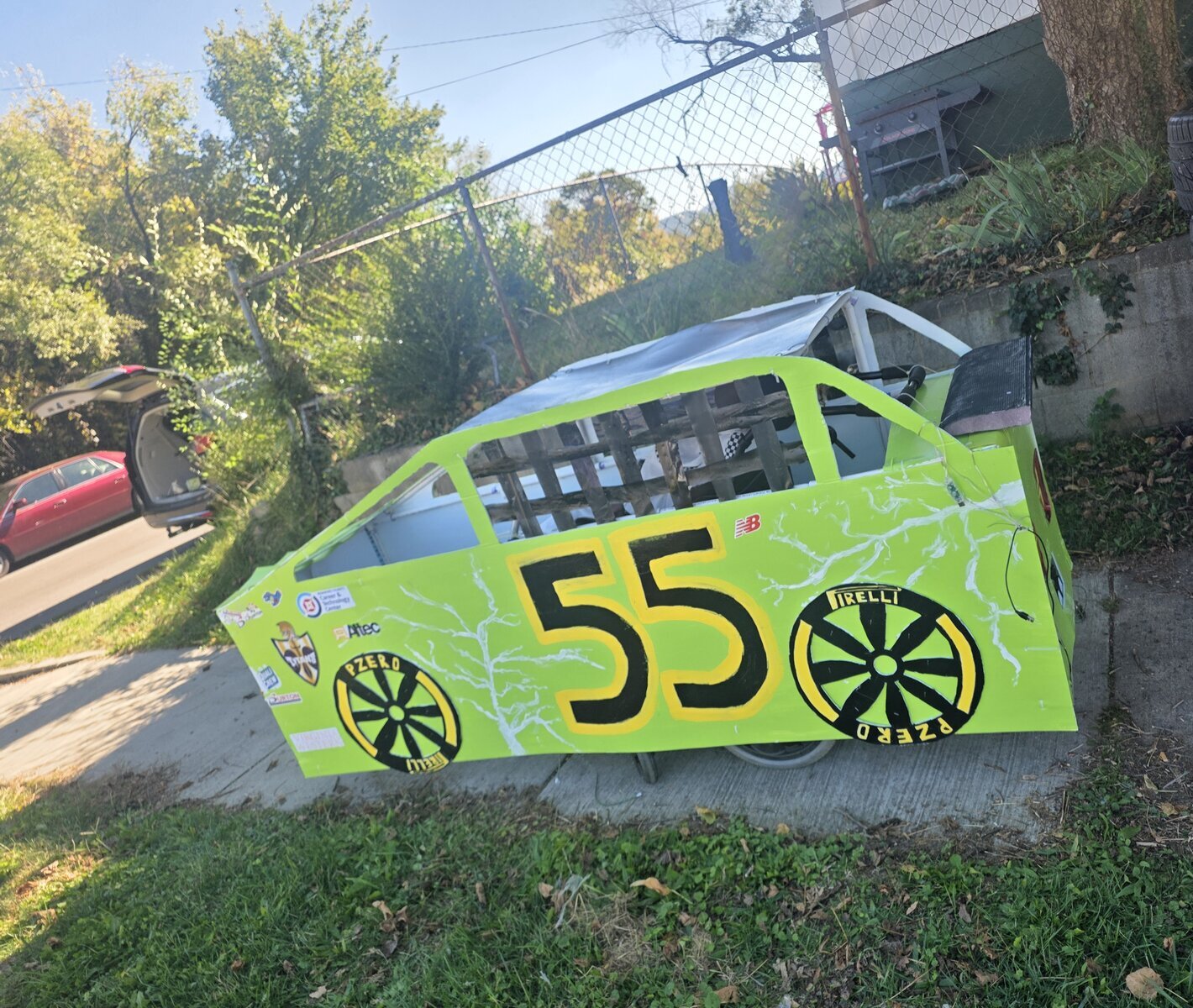 Child in a Number 55 costume on wheels