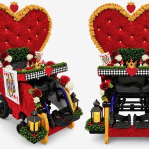 Child in a Queen of Hearts costume on wheels
