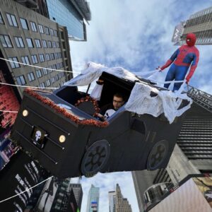 Child in a Spidey Rescues Punisher Ride costume on wheels